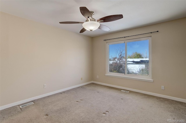 unfurnished room featuring light colored carpet and ceiling fan