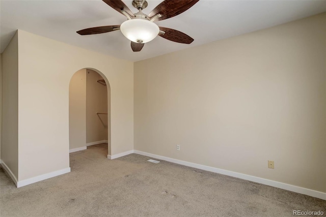 unfurnished room featuring ceiling fan and light colored carpet