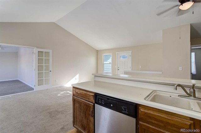 kitchen with light colored carpet, vaulted ceiling, ceiling fan, sink, and dishwasher