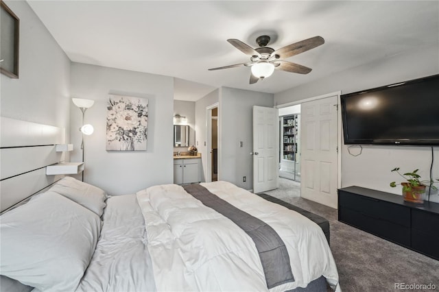 carpeted bedroom with a ceiling fan and ensuite bath
