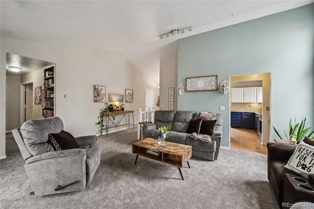 646 S Joplin St, Aurora, CO 80017 - living area with light colored carpet, high vaulted ceiling, and rail lighting