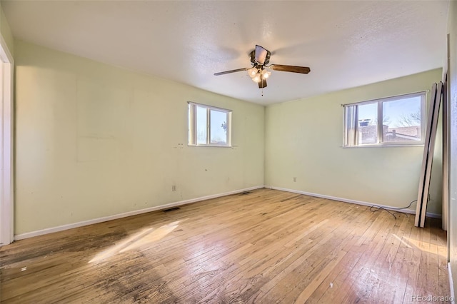 spare room with hardwood / wood-style floors and baseboards