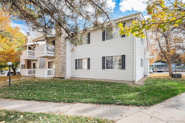 view of front of property with a balcony and a front yard