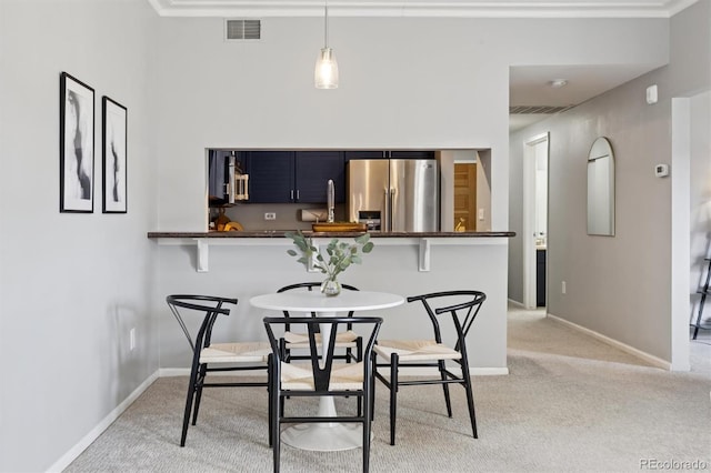 dining space with visible vents, light carpet, and baseboards