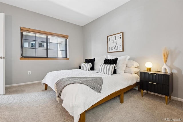 bedroom with carpet flooring and baseboards