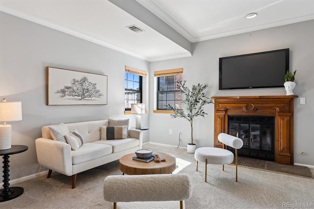 living area with a glass covered fireplace, crown molding, carpet flooring, and visible vents