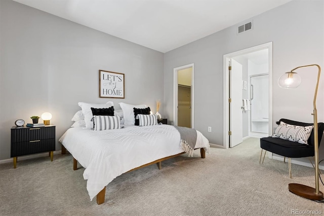 carpeted bedroom featuring baseboards and visible vents