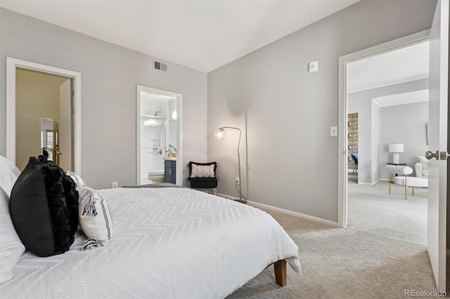 bedroom featuring visible vents, baseboards, ensuite bathroom, and carpet