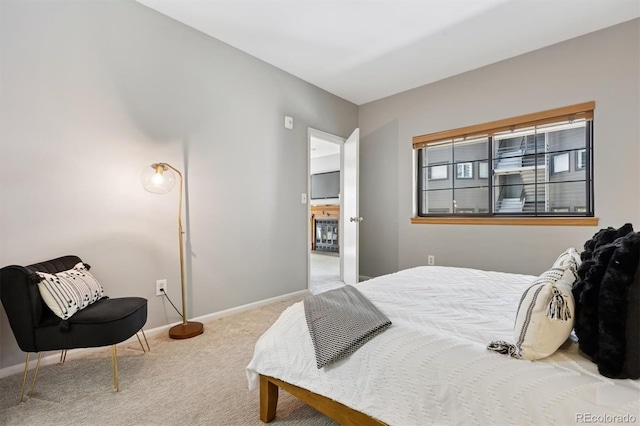 carpeted bedroom featuring baseboards