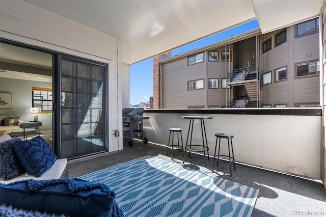 balcony featuring exterior bar and area for grilling