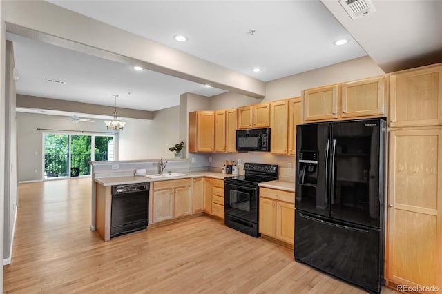 2763 W Riverwalk Cir Unit B, Littleton, CO 80123 - kitchen with black appliances, light brown cabinetry, a sink, light wood finished floors, and a peninsula