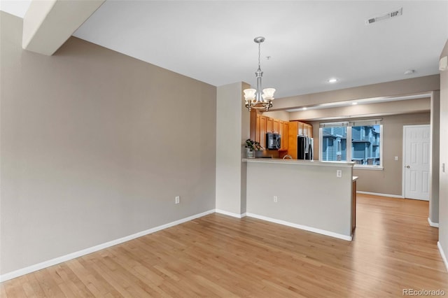 2763 W Riverwalk Cir Unit B, Littleton, CO 80123 - kitchen featuring black appliances, a chandelier, light wood finished floors, baseboards, and recessed lighting