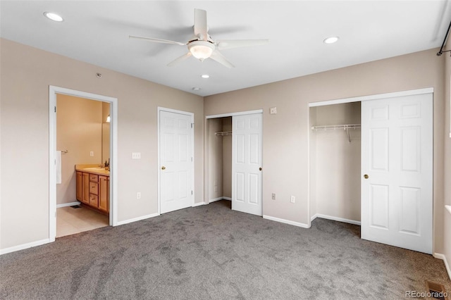 2763 W Riverwalk Cir Unit B, Littleton, CO 80123 - unfurnished bedroom with two closets, carpet, recessed lighting, baseboards, and connected bathroom