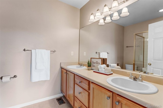 2763 W Riverwalk Cir Unit B, Littleton, CO 80123 - bathroom with an enclosed shower, toilet, double vanity, baseboards, and tile patterned floors