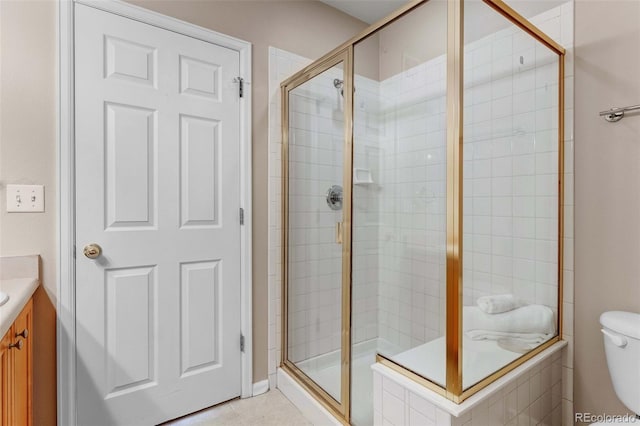 2763 W Riverwalk Cir Unit B, Littleton, CO 80123 - bathroom featuring a shower stall, vanity, toilet, and tile patterned floors