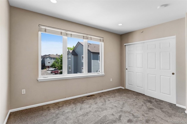 2763 W Riverwalk Cir Unit B, Littleton, CO 80123 - unfurnished bedroom with carpet flooring, baseboards, a closet, and recessed lighting