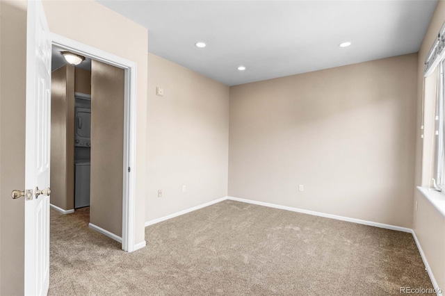 2763 W Riverwalk Cir Unit B, Littleton, CO 80123 - unfurnished room featuring stacked washer / drying machine, carpet flooring, recessed lighting, and baseboards
