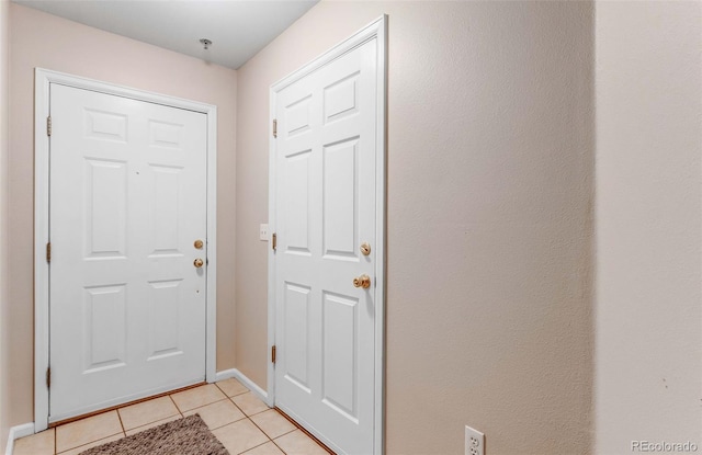 2763 W Riverwalk Cir Unit B, Littleton, CO 80123 - foyer with light tile patterned floors and baseboards