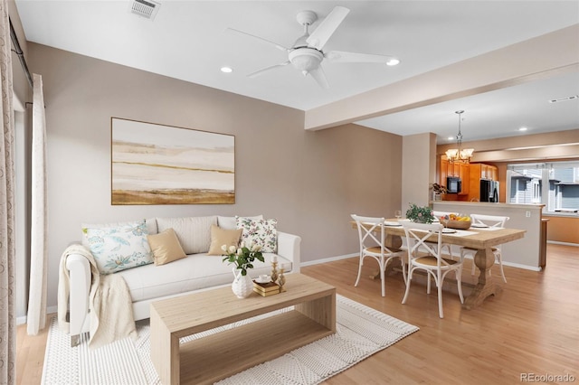 2763 W Riverwalk Cir Unit B, Littleton, CO 80123 - living room featuring light wood finished floors, baseboards, a chandelier, a ceiling fan, and recessed lighting