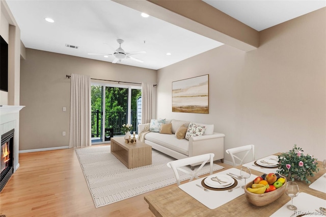 2763 W Riverwalk Cir Unit B, Littleton, CO 80123 - living room featuring a ceiling fan, light wood-style flooring, a glass covered fireplace, baseboards, and recessed lighting