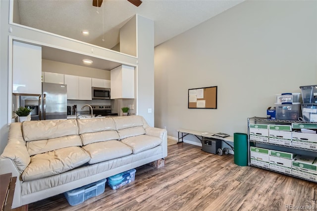 4274 S Salida Way Unit 11, Aurora, CO 80013 - living room with baseboards, high vaulted ceiling, wood finished floors, and ceiling fan