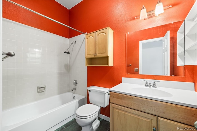 bathroom with a textured wall, toilet, vanity, baseboards, and shower / bathing tub combination