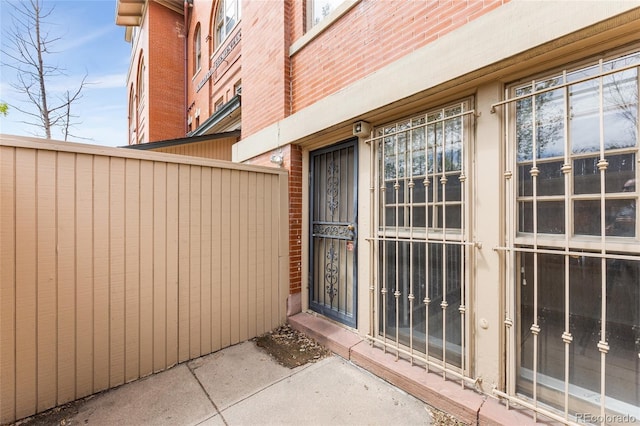 entrance to property featuring brick siding