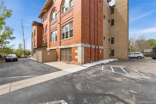 view of building exterior featuring uncovered parking