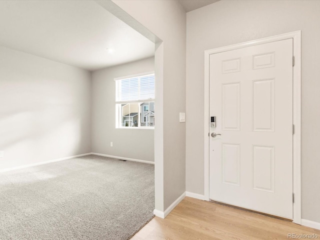 view of carpeted foyer entrance