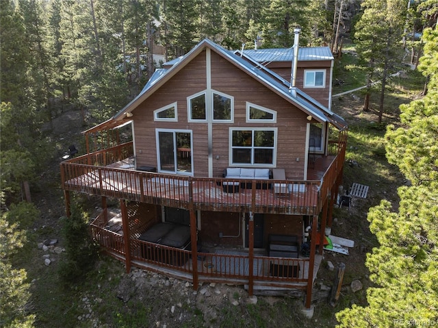 302 Texas Dr, Idaho Springs, CO 80452 - back of property featuring a deck, a metal roof, and a forest view