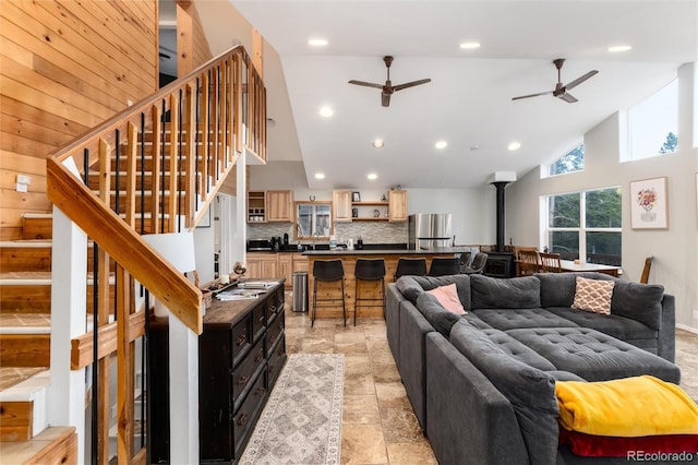 302 Texas Dr, Idaho Springs, CO 80452 - living room with a wood stove, high vaulted ceiling, ceiling fan, stairs, and recessed lighting
