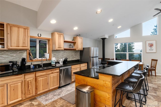 302 Texas Dr, Idaho Springs, CO 80452 - kitchen with stainless steel appliances, open shelves, backsplash, a kitchen breakfast bar, and a kitchen island