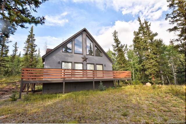 back of house featuring a wooden deck