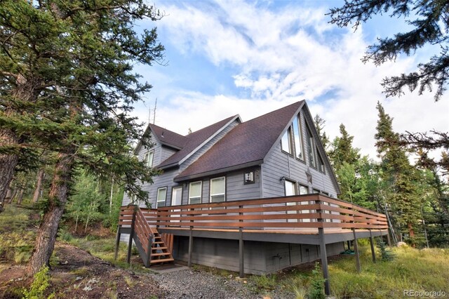 view of home's exterior with a wooden deck