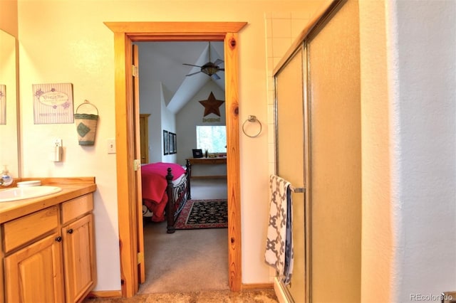 ensuite bathroom with ensuite bathroom, ceiling fan, a shower stall, and vanity