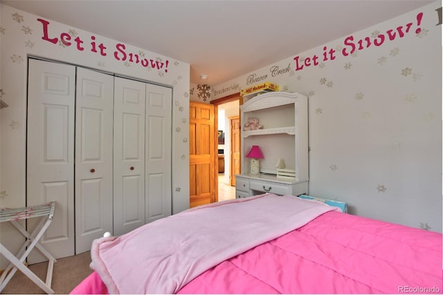 bedroom with a closet, carpet flooring, and wallpapered walls