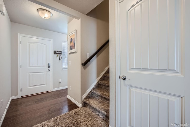 entrance foyer featuring a textured ceiling and dark hardwood / wood-style floors