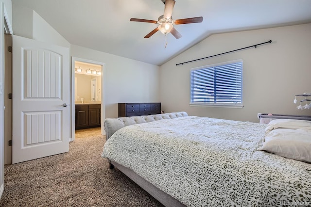 carpeted bedroom featuring vaulted ceiling, ensuite bathroom, and ceiling fan