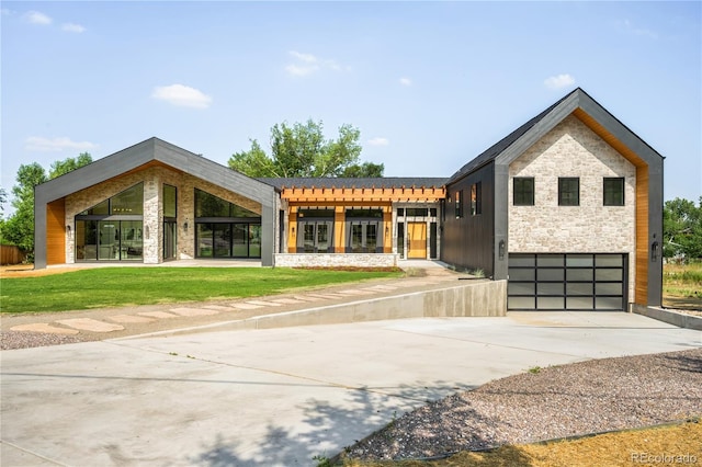 5070 Easley Rd, Golden, CO 80403 - contemporary house with stone siding, an attached garage, concrete driveway, and a front lawn