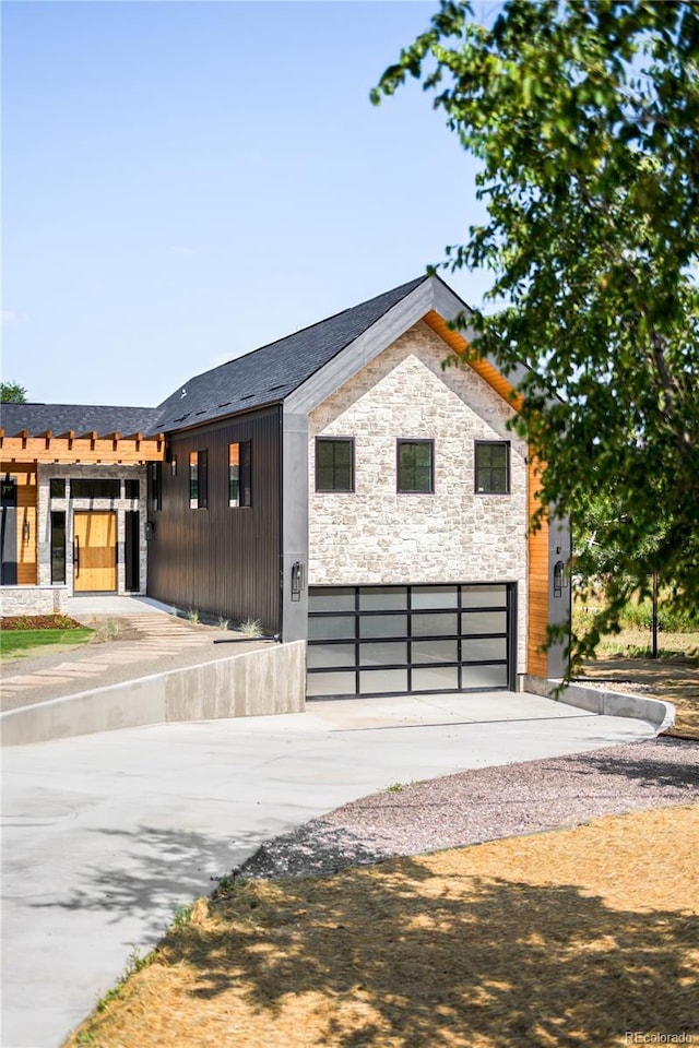 5070 Easley Rd, Golden, CO 80403 - contemporary home featuring stone siding, driveway, and an attached garage