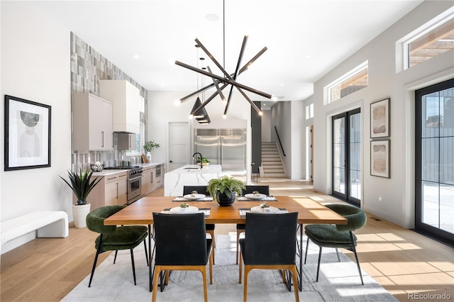 5070 Easley Rd, Golden, CO 80403 - dining area with stairway, light wood-style flooring, and a chandelier
