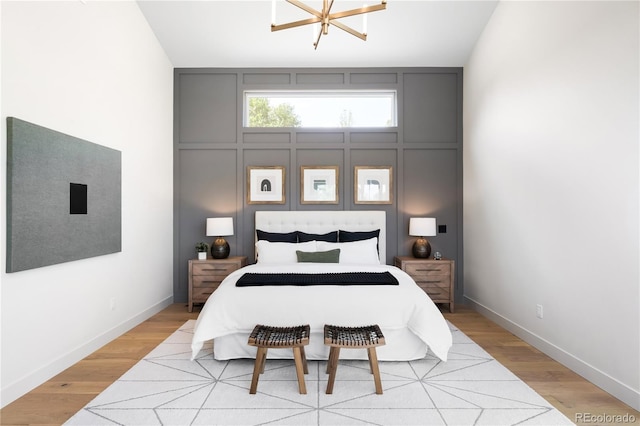 5070 Easley Rd, Golden, CO 80403 - bedroom featuring light wood-style floors, a chandelier, and lofted ceiling