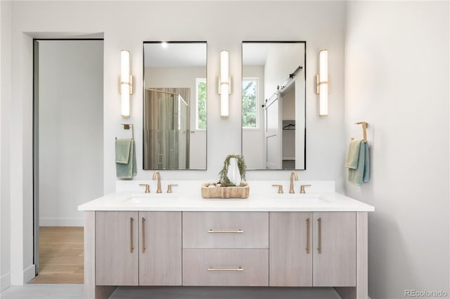5070 Easley Rd, Golden, CO 80403 - bathroom with double vanity, an enclosed shower, and wood finished floors