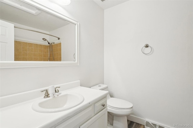 full bathroom with toilet, walk in shower, visible vents, vanity, and wood finished floors