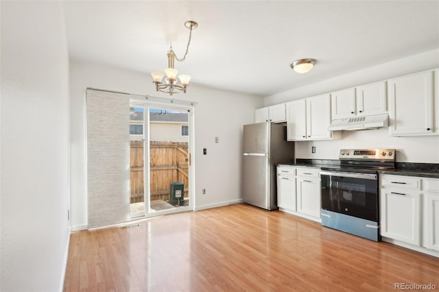 8975 Field St Unit 39, Broomfield, CO 80021 - kitchen featuring appliances with stainless steel finishes, under cabinet range hood, a chandelier, dark countertops, and light wood-style flooring
