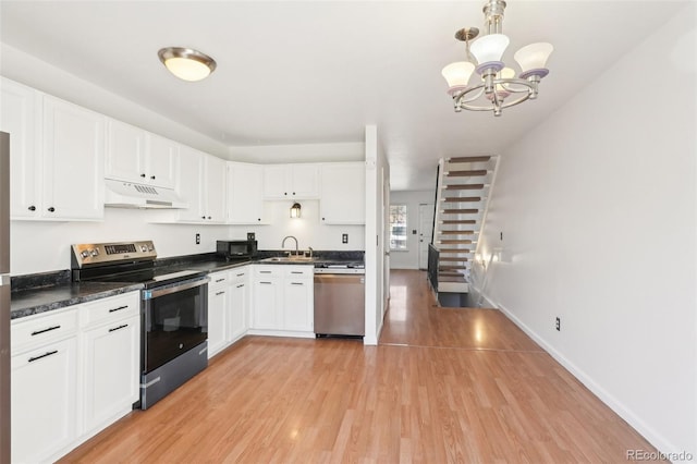 8975 Field St Unit 39, Broomfield, CO 80021 - kitchen with stainless steel appliances, under cabinet range hood, a sink, light wood-type flooring, and dark countertops
