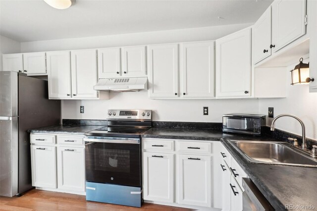 8975 Field St Unit 39, Broomfield, CO 80021 - kitchen with under cabinet range hood, appliances with stainless steel finishes, a sink, and white cabinets