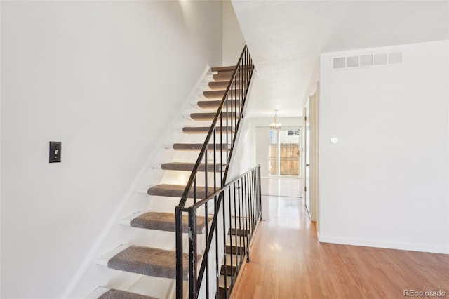 8975 Field St Unit 39, Broomfield, CO 80021 - stairs with wood finished floors, baseboards, and a chandelier