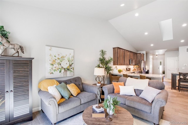 living room with french doors, wood-type flooring, high vaulted ceiling, and sink