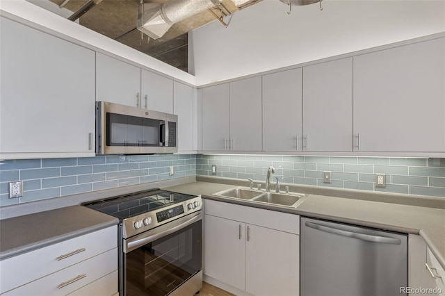 2020 Arapahoe St Unit 970, Denver, CO 80205 - kitchen featuring appliances with stainless steel finishes, a sink, tasteful backsplash, and light countertops